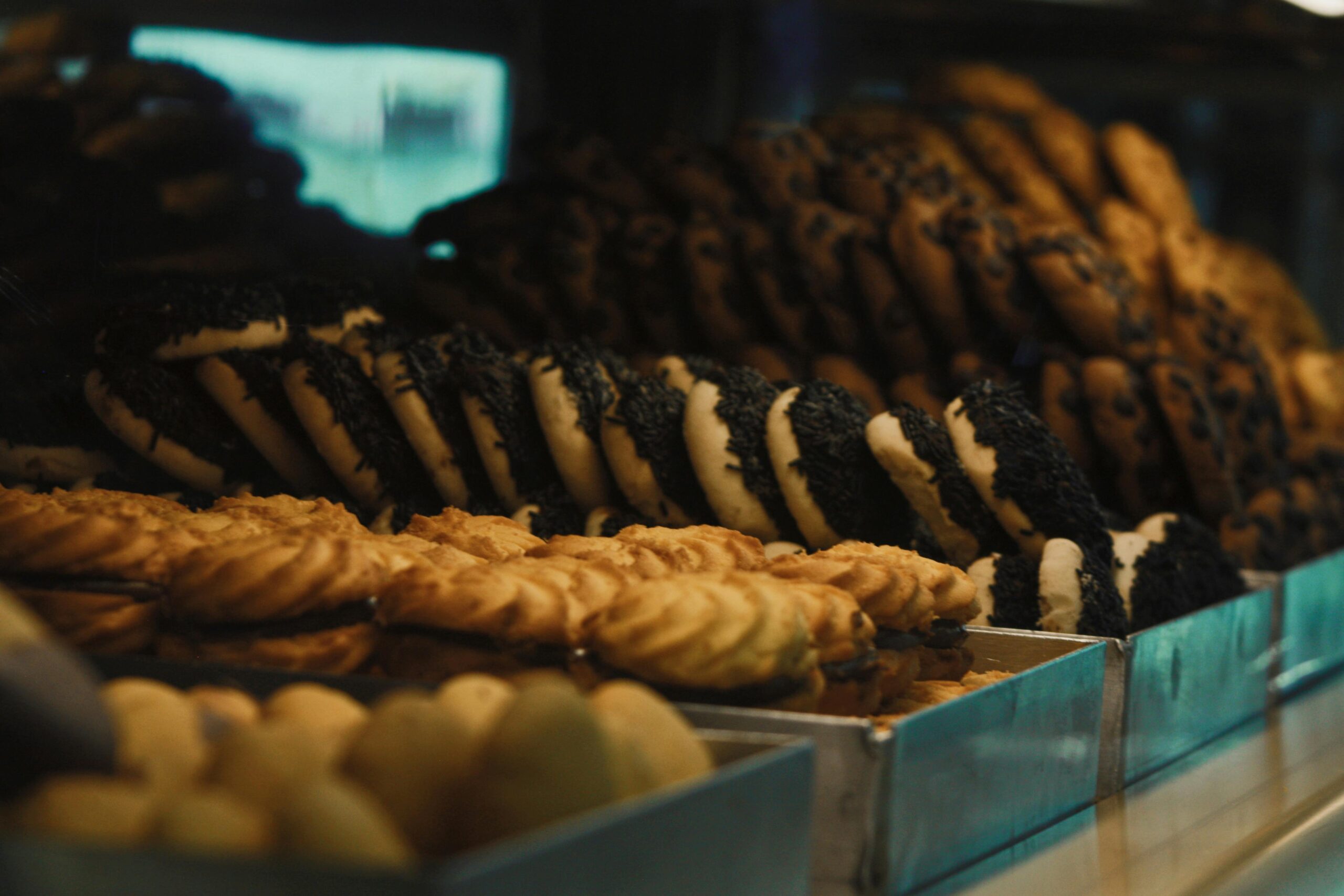 Delicious assortment of freshly baked cookies in a bakery display, showcasing variety and texture.